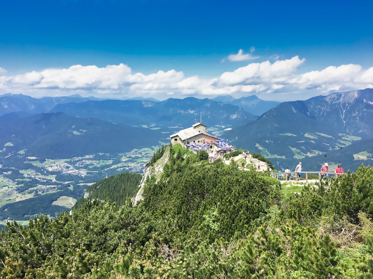 Aerial view of Kehlsteinhaus on a sunny day in Berchtesgaden, Germany, surrounded by alpine mountains.